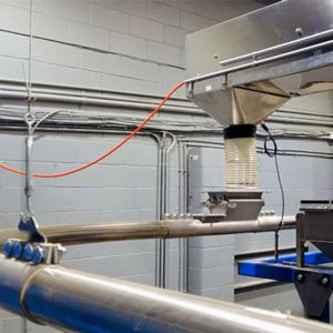 At the rear of the building, beans from the roaster are discharged from a bucket elevator into the Tubular Cable Conveyor.